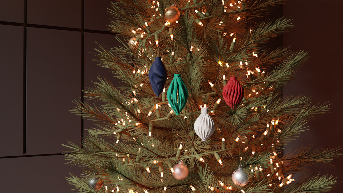 Small ribbed bauble ornaments on a Christmas tree with lights