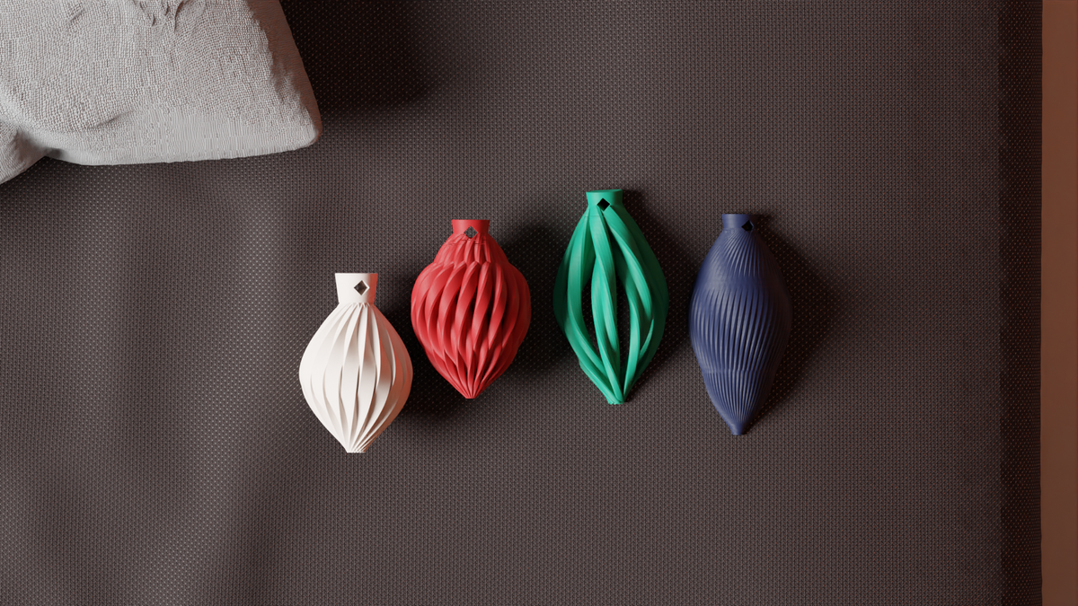 Set of 4 bauble shapes in white, red, green and blue laid flat
