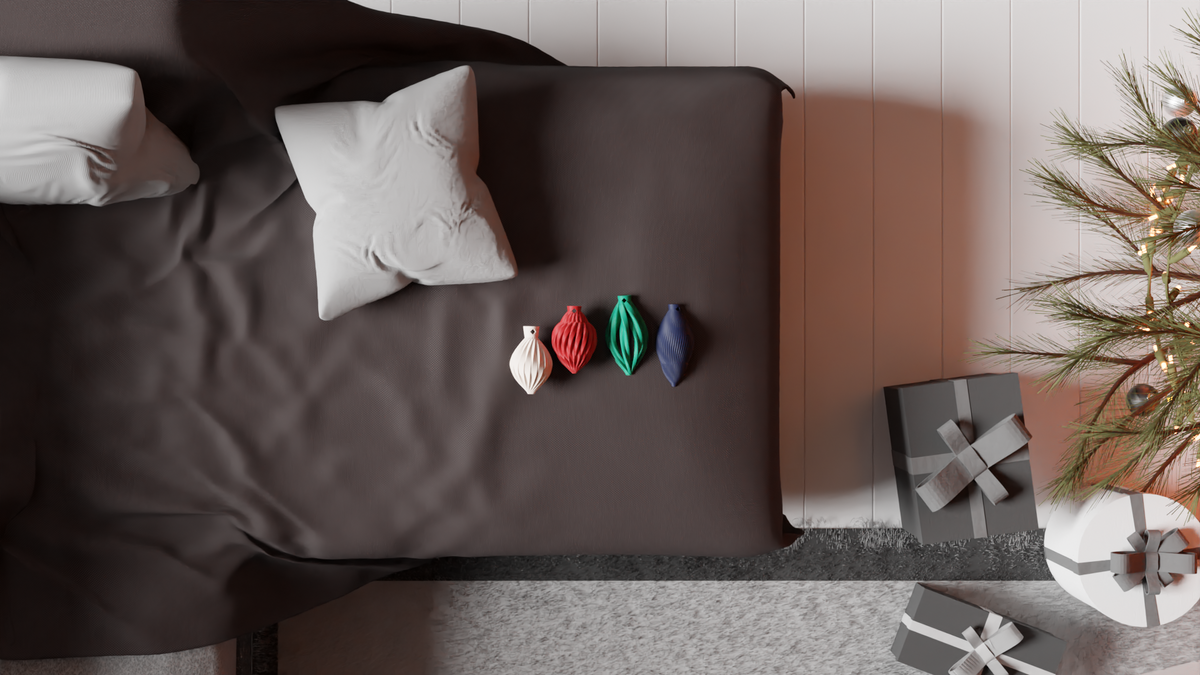 Set of 4 Christmas baubles shown beside a bed with gifts