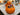 Orange pumpkin candy bowl with monster hand gripping the handle, filled with wrapped candy on a Halloween counter