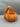 Orange monster hand pumpkin candy bowl, studio front view on a gray background
