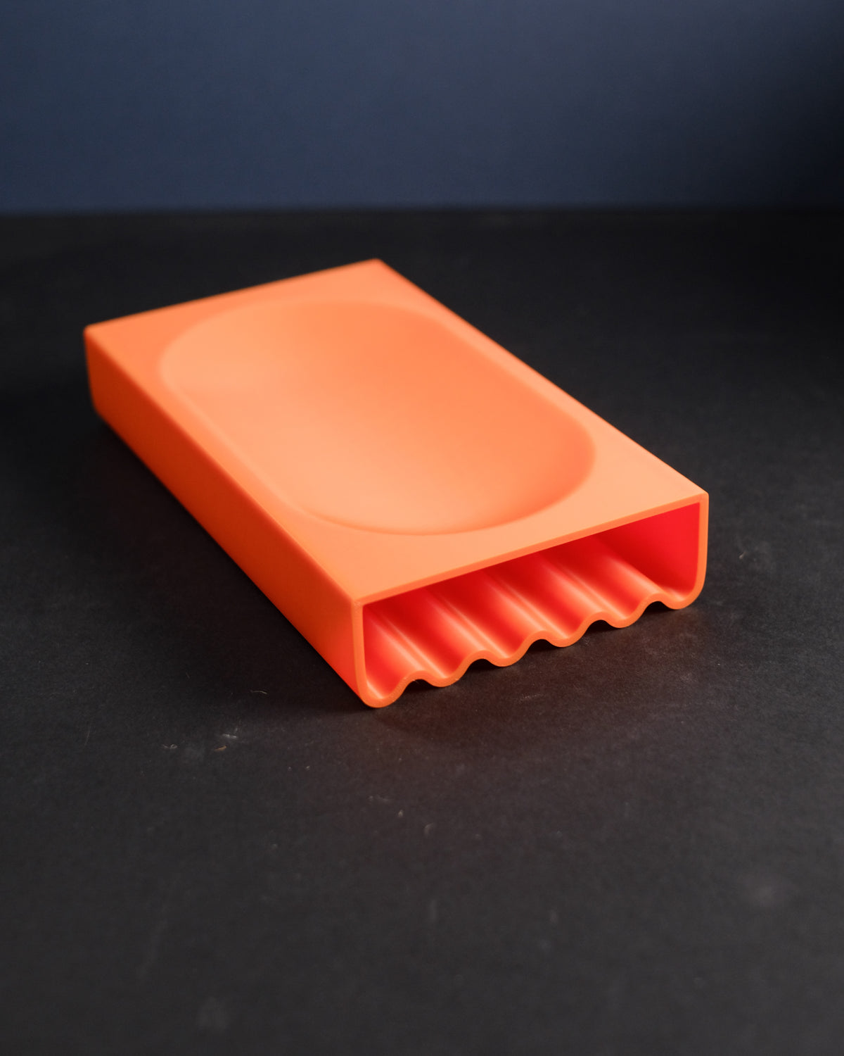 Minimalist desk catch-all tray with wavy pen channel underneath
