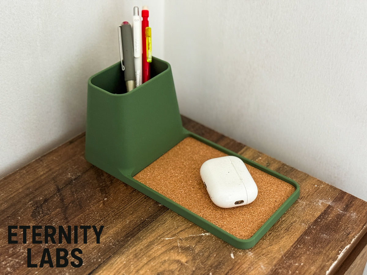 Long tray desk organizer with pen pot holding pens and earbuds in the tray
