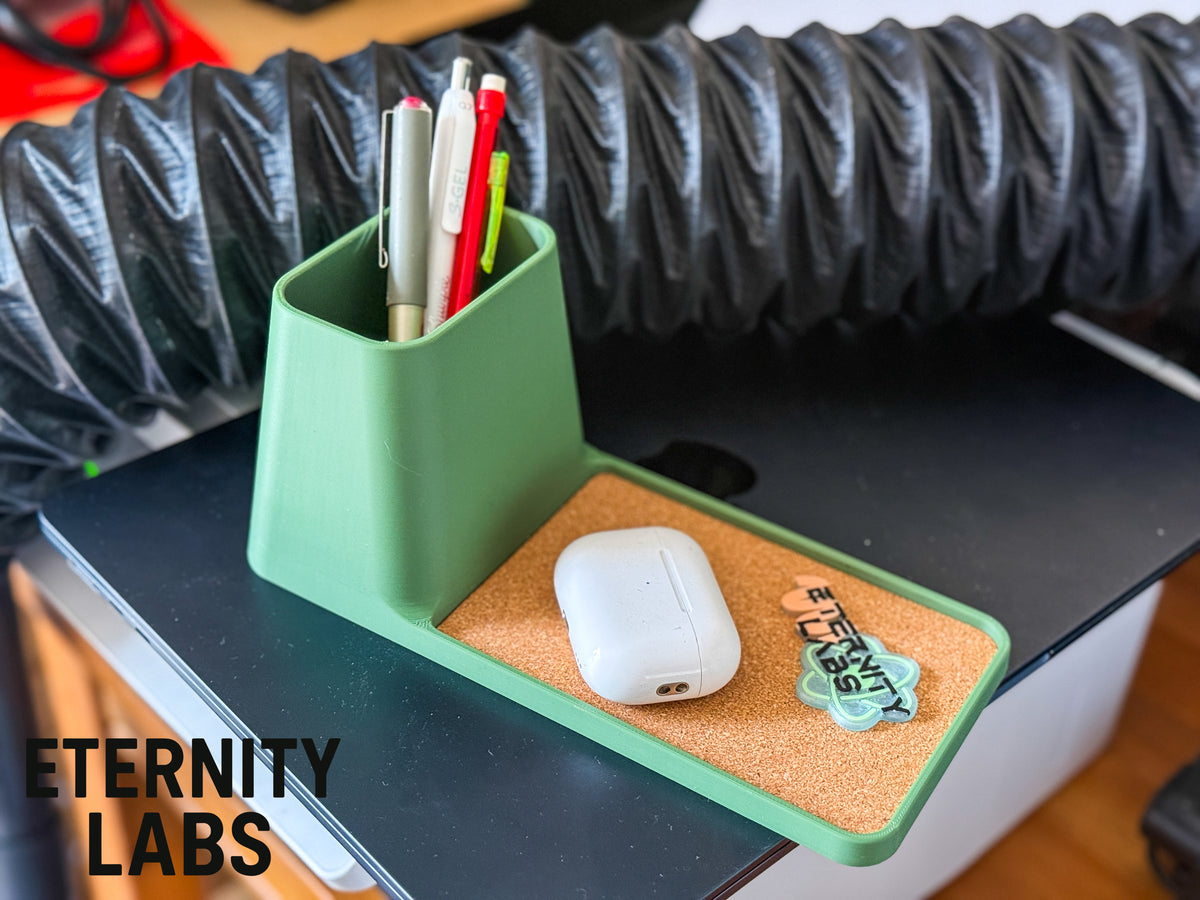 Long tray desk organizer on a desk with pens, earbuds and keys
